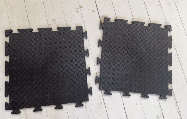 Black interlinking floor tiles